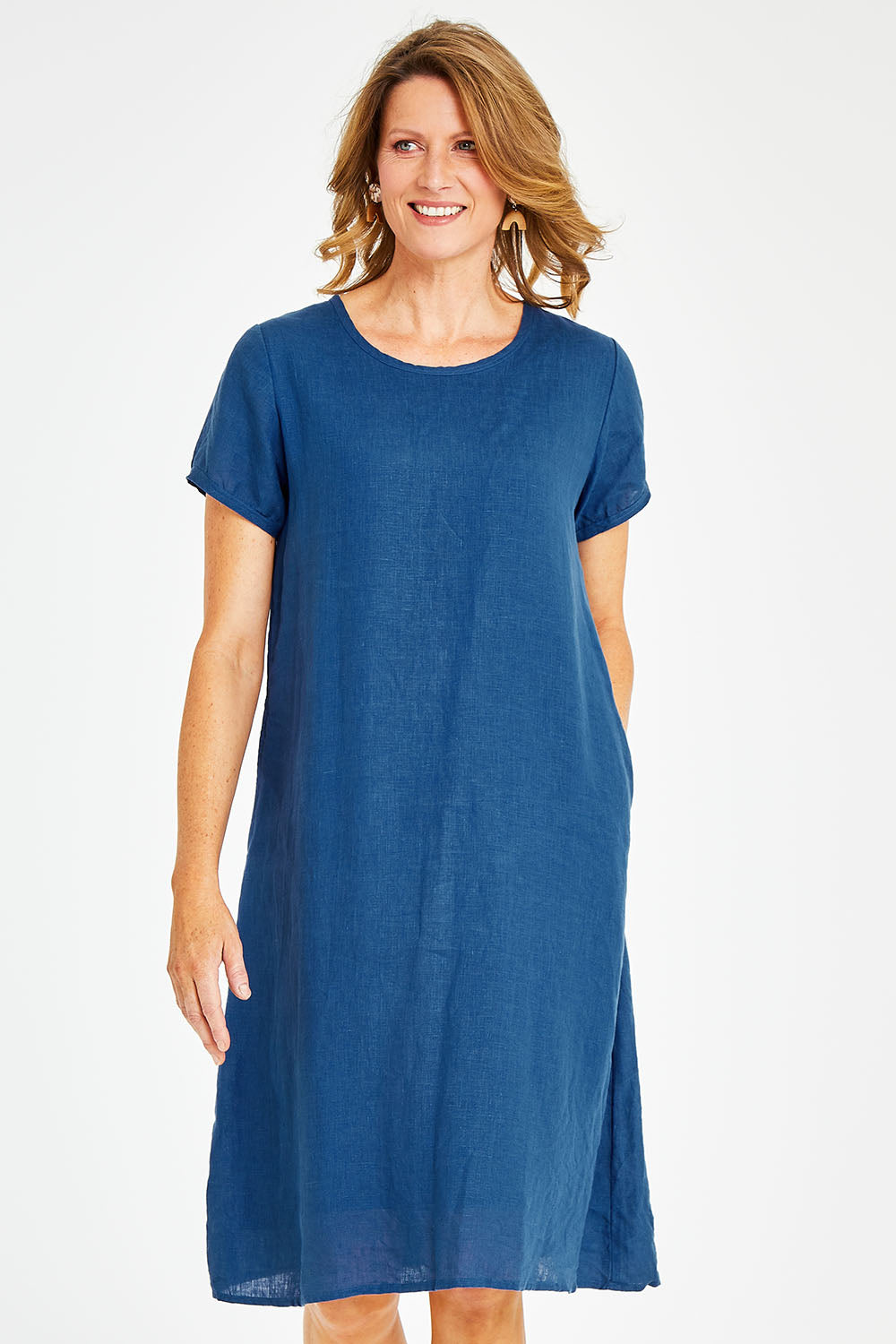 Model Naomi wearing size S of the Sabi Dress in colour Ocean (Blue), from the front, cropped image