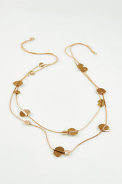 A model wearing the Toronto Necklace in colour Gold (Metallics), from the front, showing the whole outfit