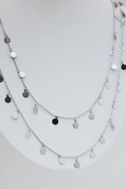 A model wearing the Cosmos Necklace in colour Silver (Metallics), from the front, showing the whole outfit