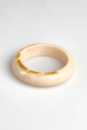A model wearing the Bower Bangle in colour Natural, from the front, showing the whole outfit