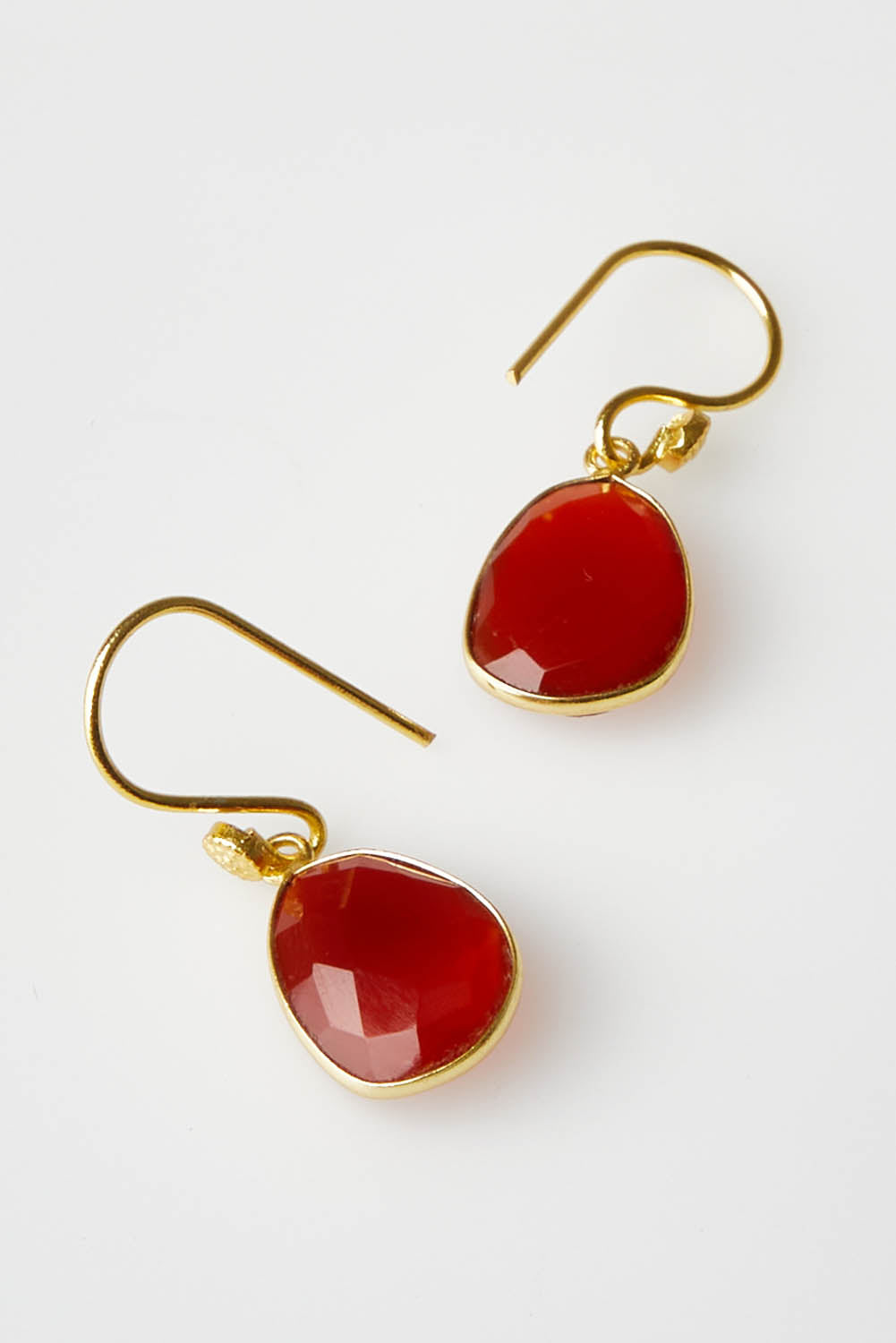 A model wearing size OneSize of the Carrie Earrings in colour Ruby (Red), from the front, showing the whole outfit