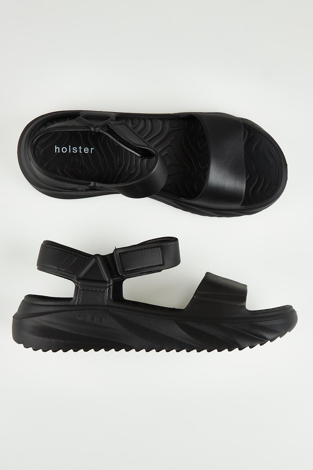 A model wearing size 6 of the Cloud Nine Eva Sandal in colour Black (Black), from the front, showing the whole outfit