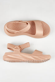 A model wearing size 7 of the Cloud Nine Eva Sandal in colour Natural, from the front, showing the whole outfit