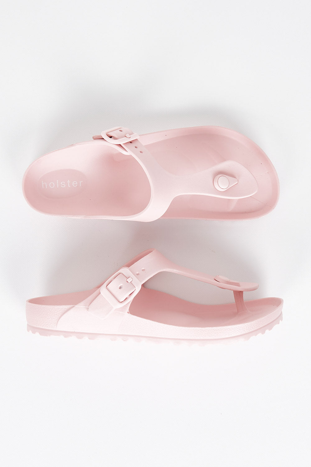 A model wearing size 7 of the Coastal EVA Slide in colour Blush (Pink), from the front, showing the whole outfit