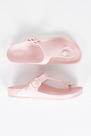 A model wearing size 7 of the Coastal EVA Slide in colour Blush (Pink), from the front, showing the whole outfit