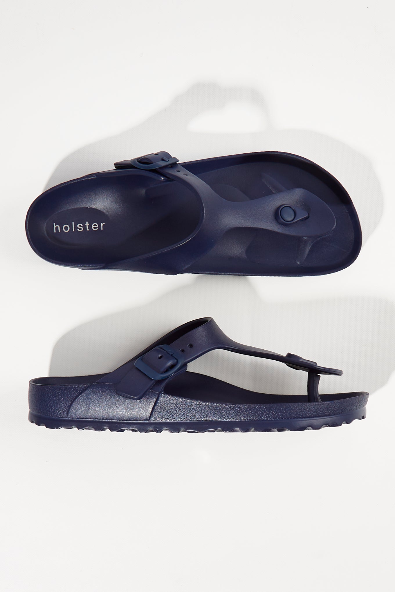 A model wearing size 6 of the Coastal EVA Slide in colour Navy (Blue), from the front, showing the whole outfit