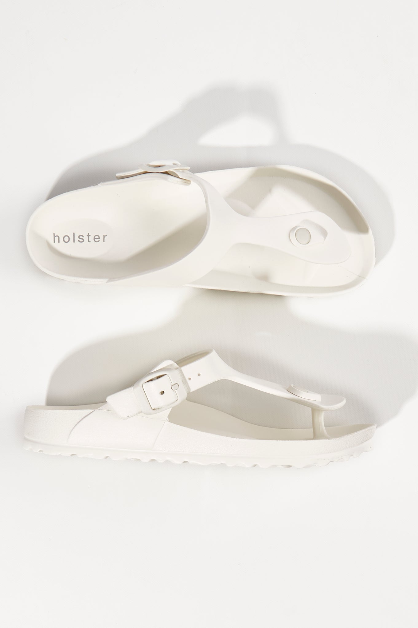 A model wearing size 6 of the Coastal EVA Slide in colour White (White), from the front, showing the whole outfit