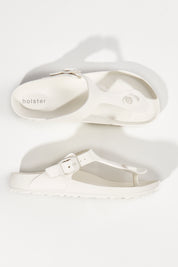 A model wearing size 6 of the Coastal EVA Slide in colour White (White), from the front, showing the whole outfit