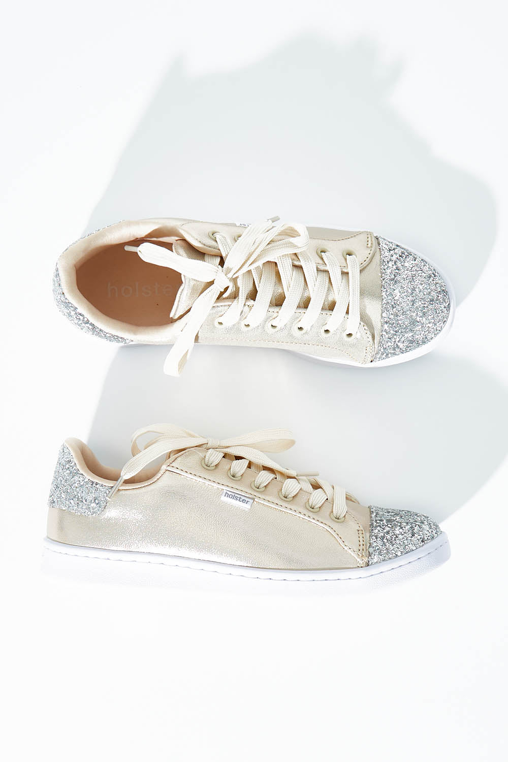 A model wearing size 7 of the Stardust Sneaker in colour Champagne, from the front, showing the whole outfit