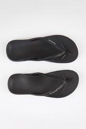 Model Genericm wearing size sample of the Islander Thong - Black in colour Black, in a cropped view