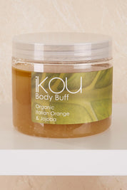 A model wearing the Organic Body Buff in colour Orange (White), from the front, showing the whole outfit