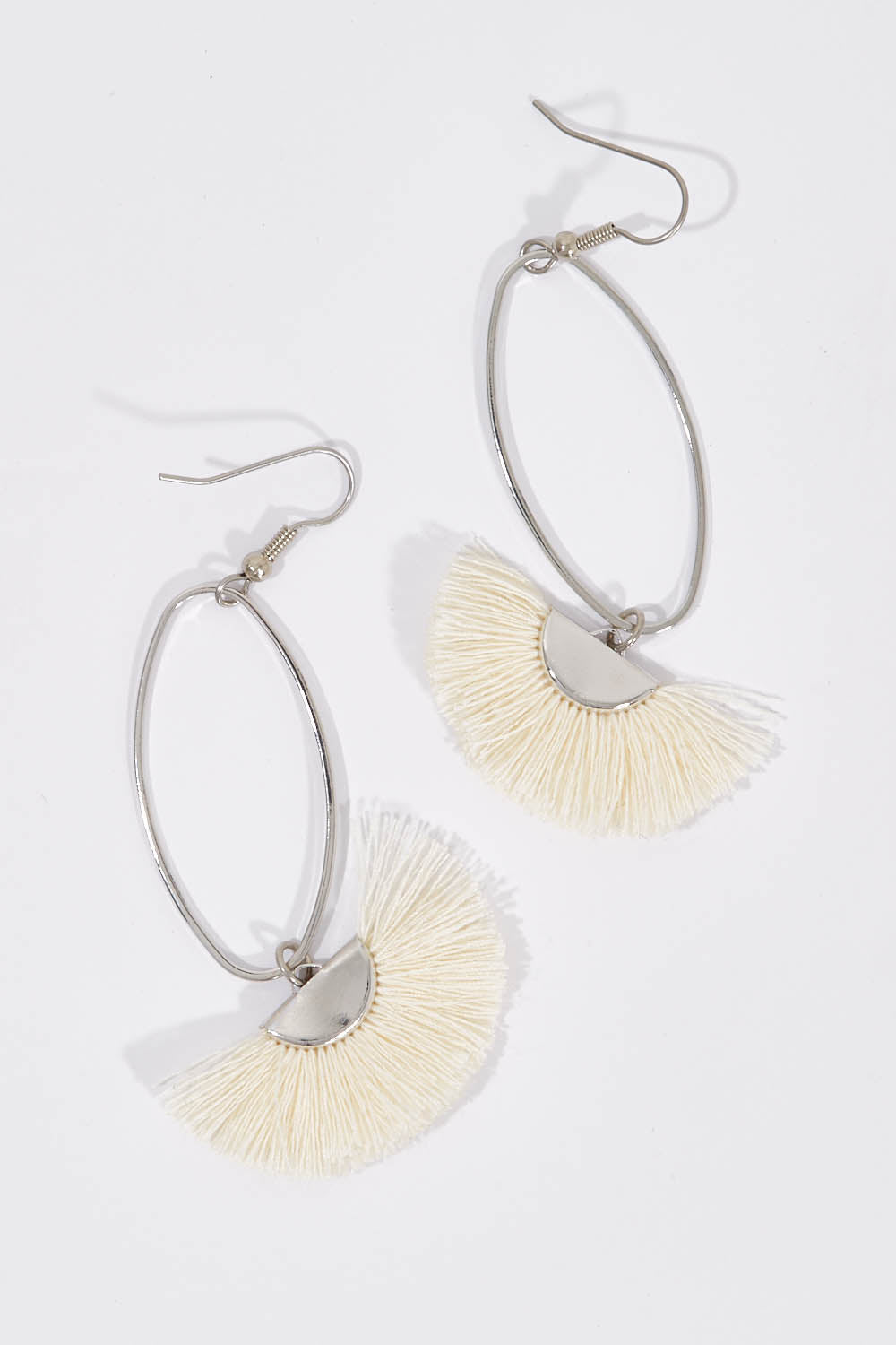 A model wearing size OneSize of the Silver Caprioska Tassel Earrings in colour Ivory (White), from the front, showing the whole outfit