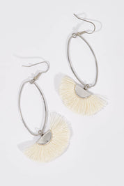 A model wearing size OneSize of the Silver Caprioska Tassel Earrings in colour Ivory (White), from the front, showing the whole outfit