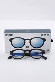A model wearing size 0 of the Blue Light Filter Rectangular Reading Glasses in colour Black (Black), from the front, showing the whole outfit