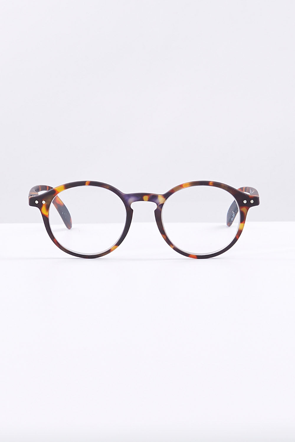 A model wearing size 1 of the D Round Reading Glasses in colour Tortoise, from the front, showing the whole outfit