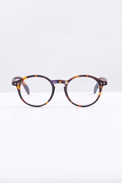 A model wearing size 1 of the D Round Reading Glasses in colour Tortoise, from the front, showing the whole outfit