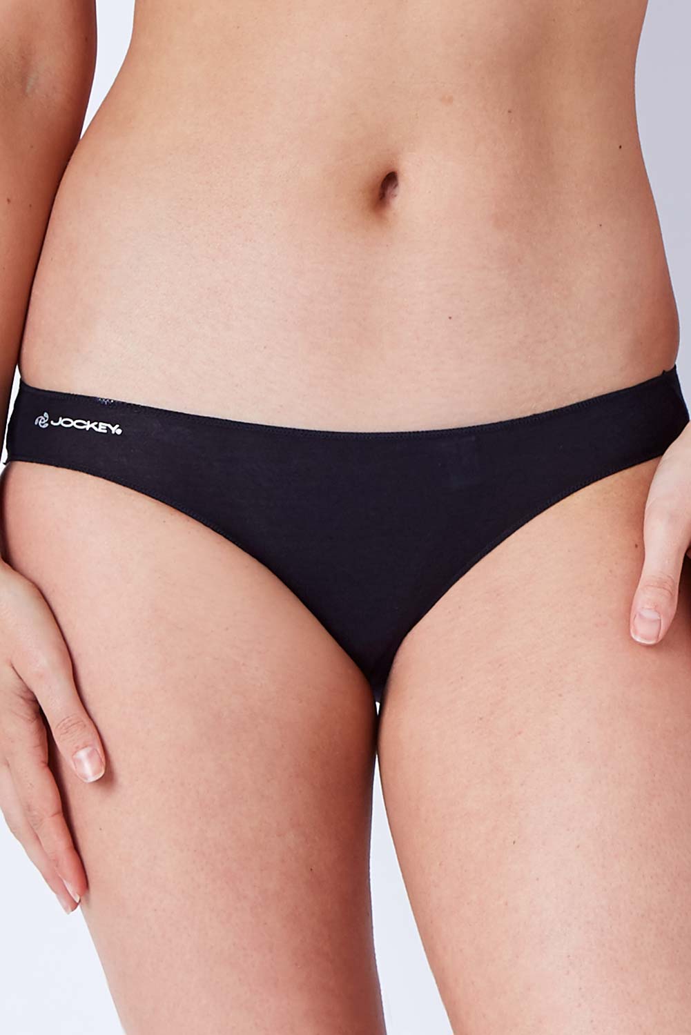 Model Phoebe wearing size 10 of the Bamboo Naturals Bikini Brief in colour Black (Black), from the front, cropped image