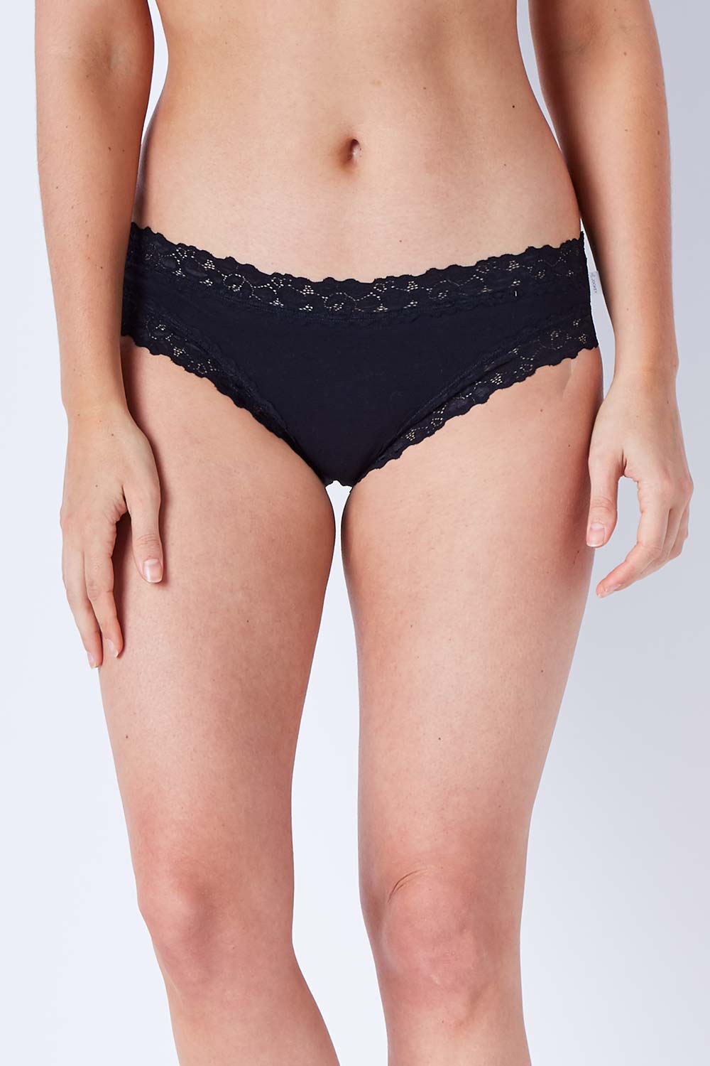 Model Phoebe wearing size 10 of the Parisienne Cotton Bikini in colour Black (Black), from the front, cropped image