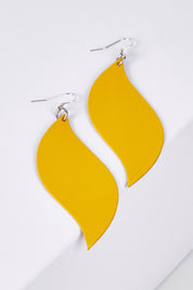 A model wearing size OneSize of the Australian Made Bold Single Leaf Leather Earring in colour Daffodil, from the front, showing the whole outfit