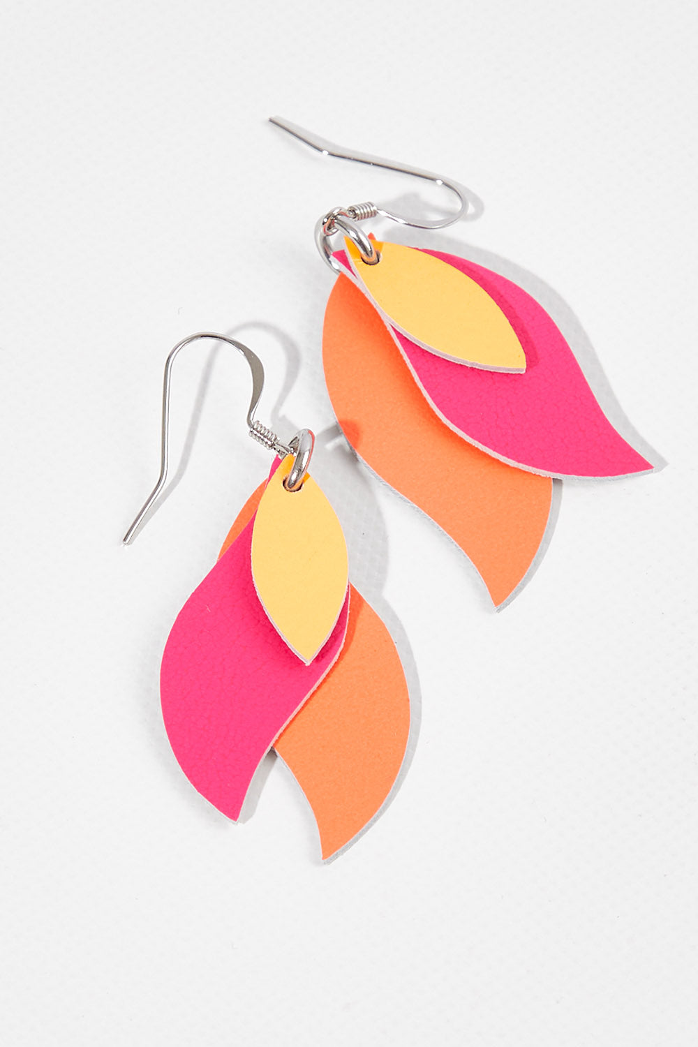 A model wearing size OneSize of the Australian Made Leather Leaf Earring in colour Pinktanger (Pink), from the front, showing the whole outfit