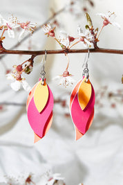 A model wearing size OneSize of the Australian Made Leather Leaf Earring in colour Pinktanger (Pink), from the front, showing the whole outfit