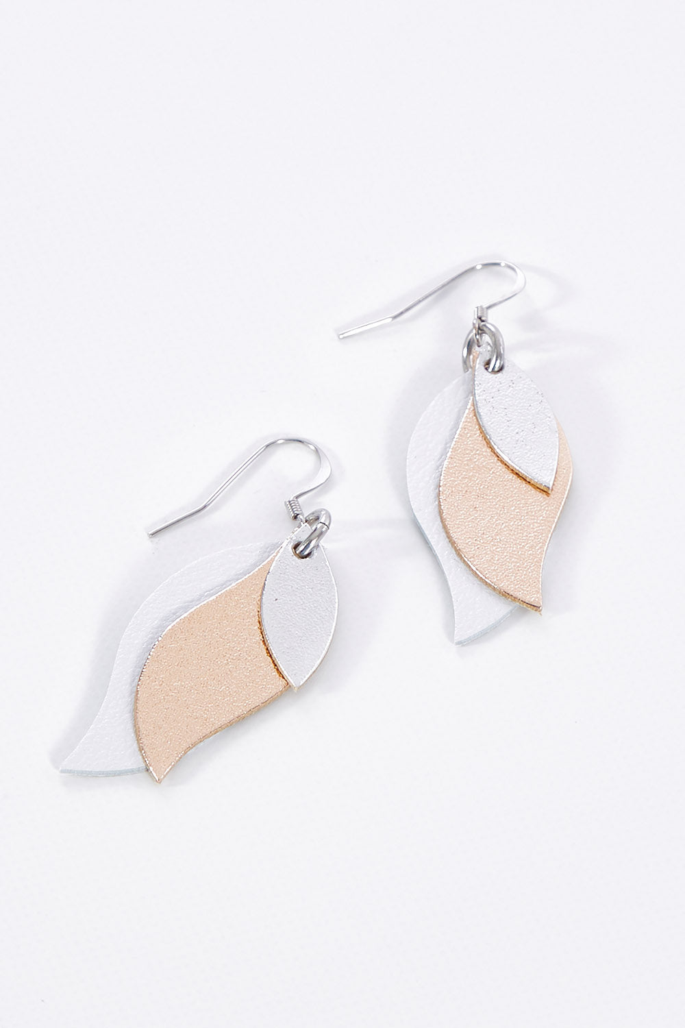 A model wearing size OneSize of the Australian Made Leather Leaf Earring in colour Silveroseg (Metallics), from the front, showing the whole outfit