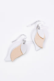 A model wearing size OneSize of the Australian Made Leather Leaf Earring in colour Silveroseg (Metallics), from the front, showing the whole outfit
