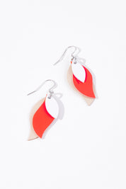 A model wearing size OneSize of the Australian Made Leather Leaf Earring in colour Whitecoral (Pink), from the front, showing the whole outfit