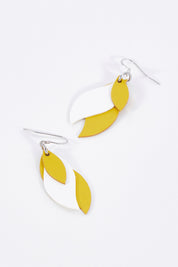 A model wearing size OneSize of the Australian Made Leather Leaf Earring in colour Yellowhite, from the front, showing the whole outfit