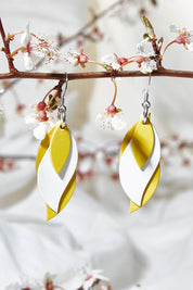 A model wearing size OneSize of the Australian Made Leather Leaf Earring in colour Yellowhite, from the front, showing the whole outfit
