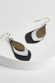 A model wearing size OneSize of the Australian Made Leather Teardrop Earring in colour Navy (Blue), from the front, showing the whole outfit