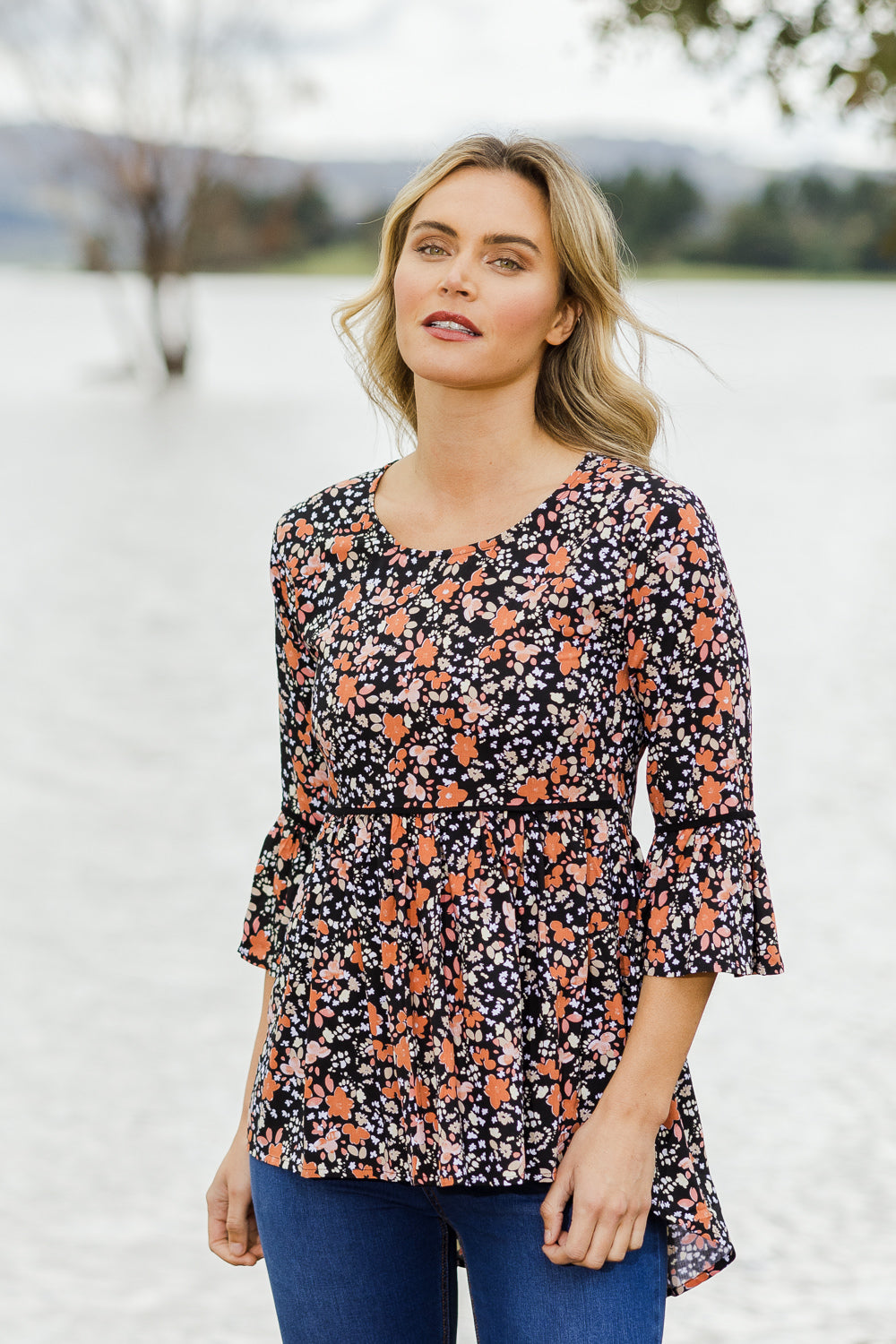 Model Alice wearing size 10 of the Aria Top in colour Blackprint (Black), from the front, showing the whole outfit