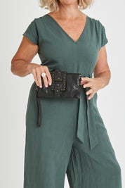 Model Sandy wearing size OneSize of the Femi Leather Crossbody in colour Black (Black), from the front, cropped image