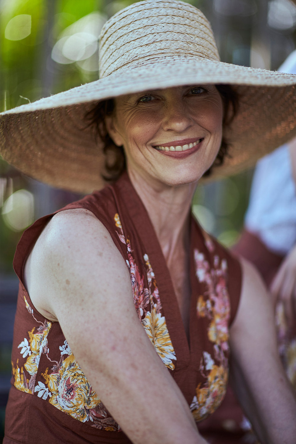 A model wearing the Stephanie Dress in colour Anise, from the front, showing the whole outfit