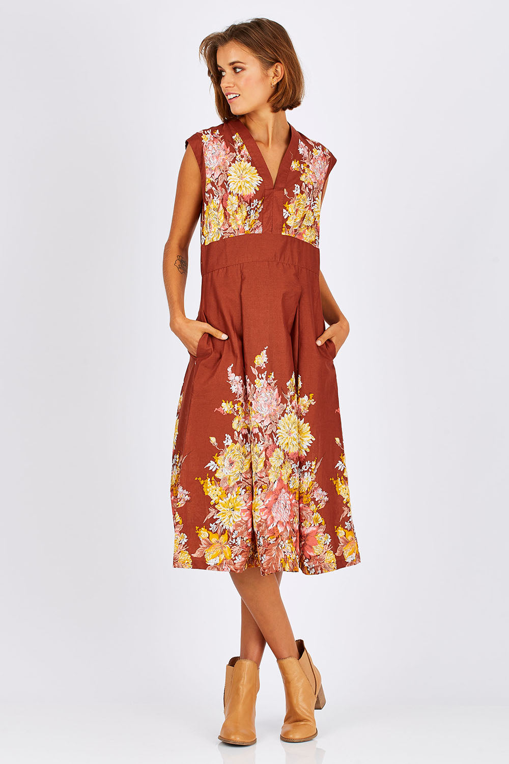 Model Nikki wearing size S of the Stephanie Dress in colour Anise, from the front, showing the whole outfit