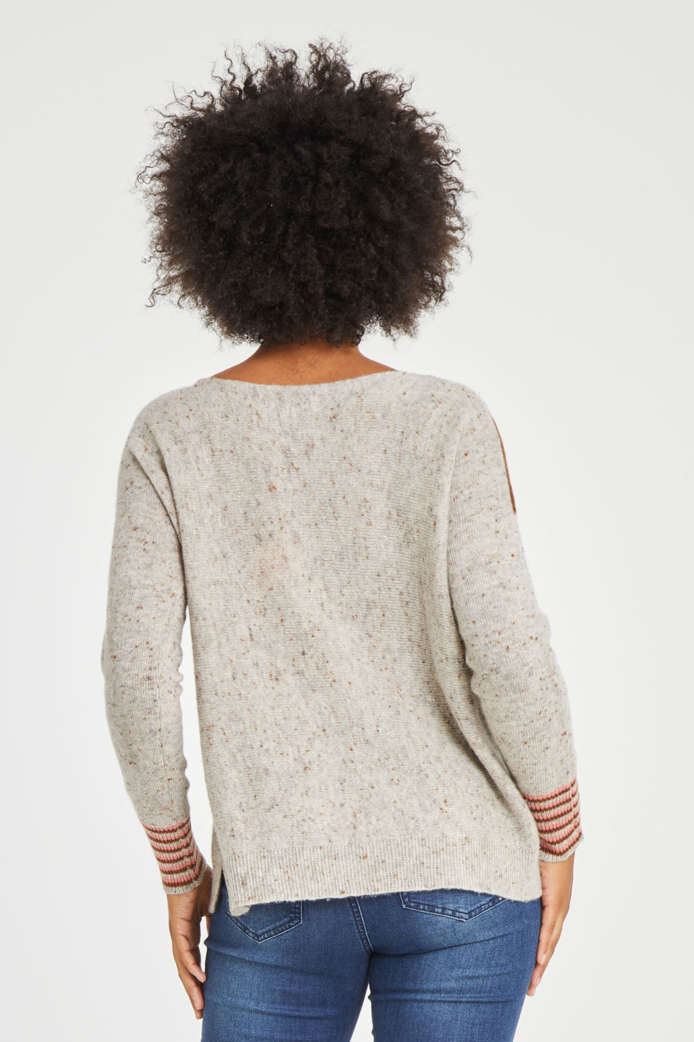Model Olivia wearing size S of the Whirlwind Jumper in colour Earth, from the back