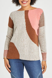 Model Olivia wearing size S of the Whirlwind Jumper in colour Earth, from the front, cropped image