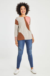 Model Olivia wearing size S of the Whirlwind Jumper in colour Earth, from the front, showing the whole outfit