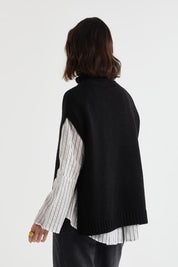 A model wearing the Lofty Tunic in colour Black (Black), from the back