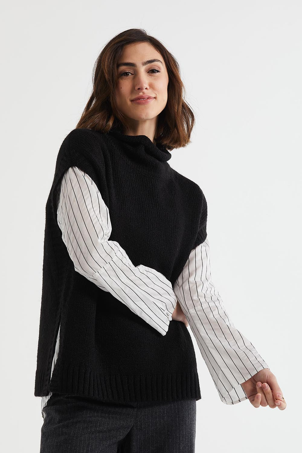 A model wearing the Lofty Tunic in colour Black (Black), from the front, cropped image