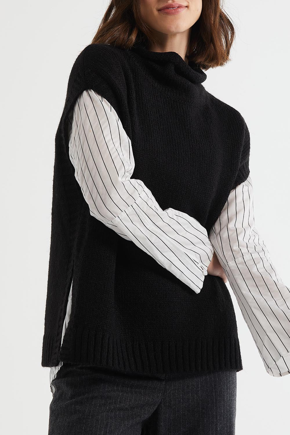 A model wearing the Lofty Tunic in colour Black (Black), from the front, cropped image