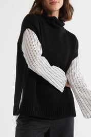 A model wearing the Lofty Tunic in colour Black (Black), from the front, cropped image