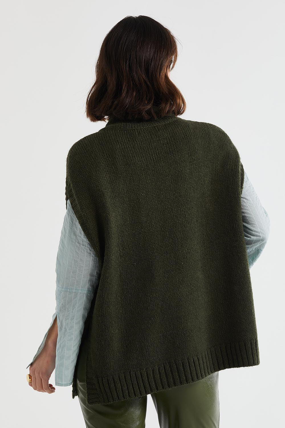A model wearing the Lofty Tunic in colour Olive (Green), from the back