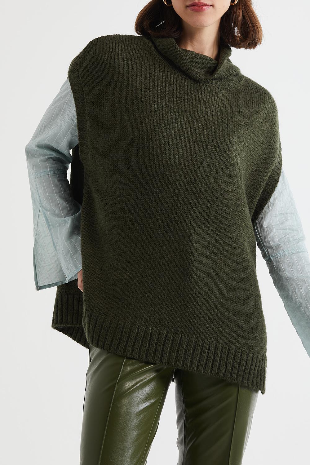 A model wearing the Lofty Tunic in colour Olive (Green), from the front, cropped image