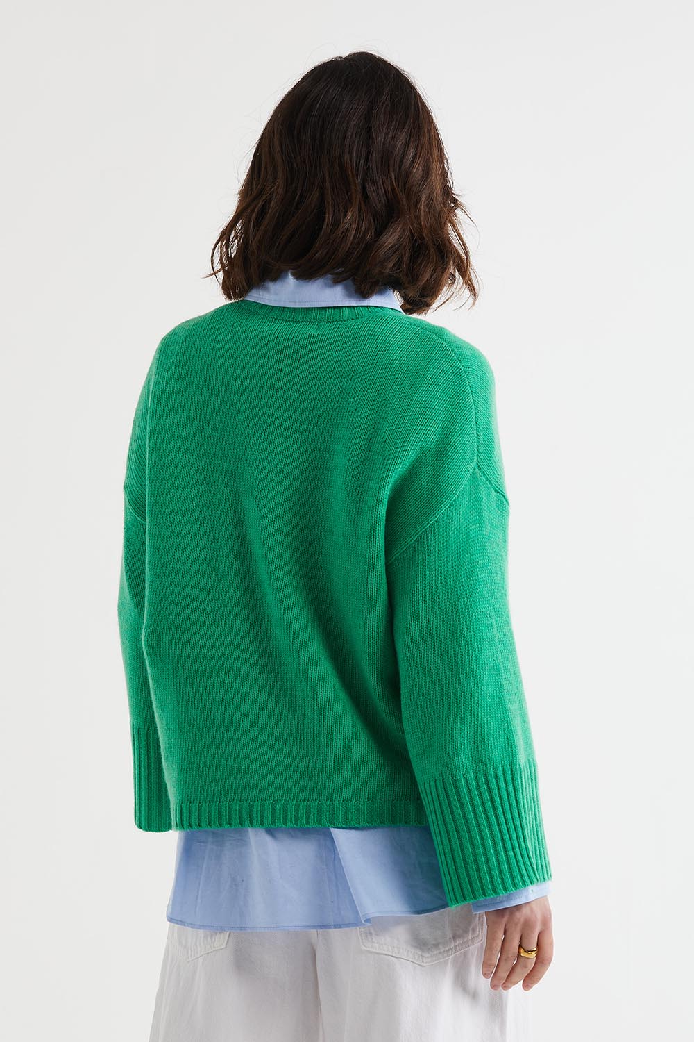 A model wearing the Wide Sleeve Lambswool Crew in colour Parakeet (Green), from the back