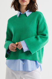 A model wearing the Wide Sleeve Lambswool Crew in colour Parakeet (Green), from the front, cropped image