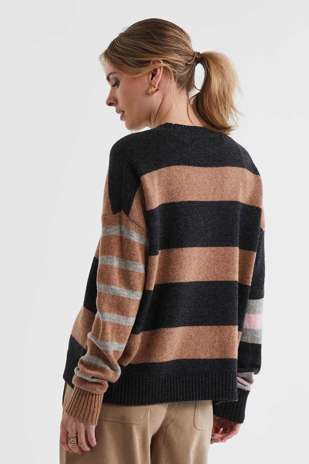 A model wearing the Lambswool Stripe Crew in colour Midnight, from the back