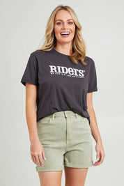 Model Grace wearing size 10 of the Girlfriend Short in colour Thyme (Green), from the front, cropped image