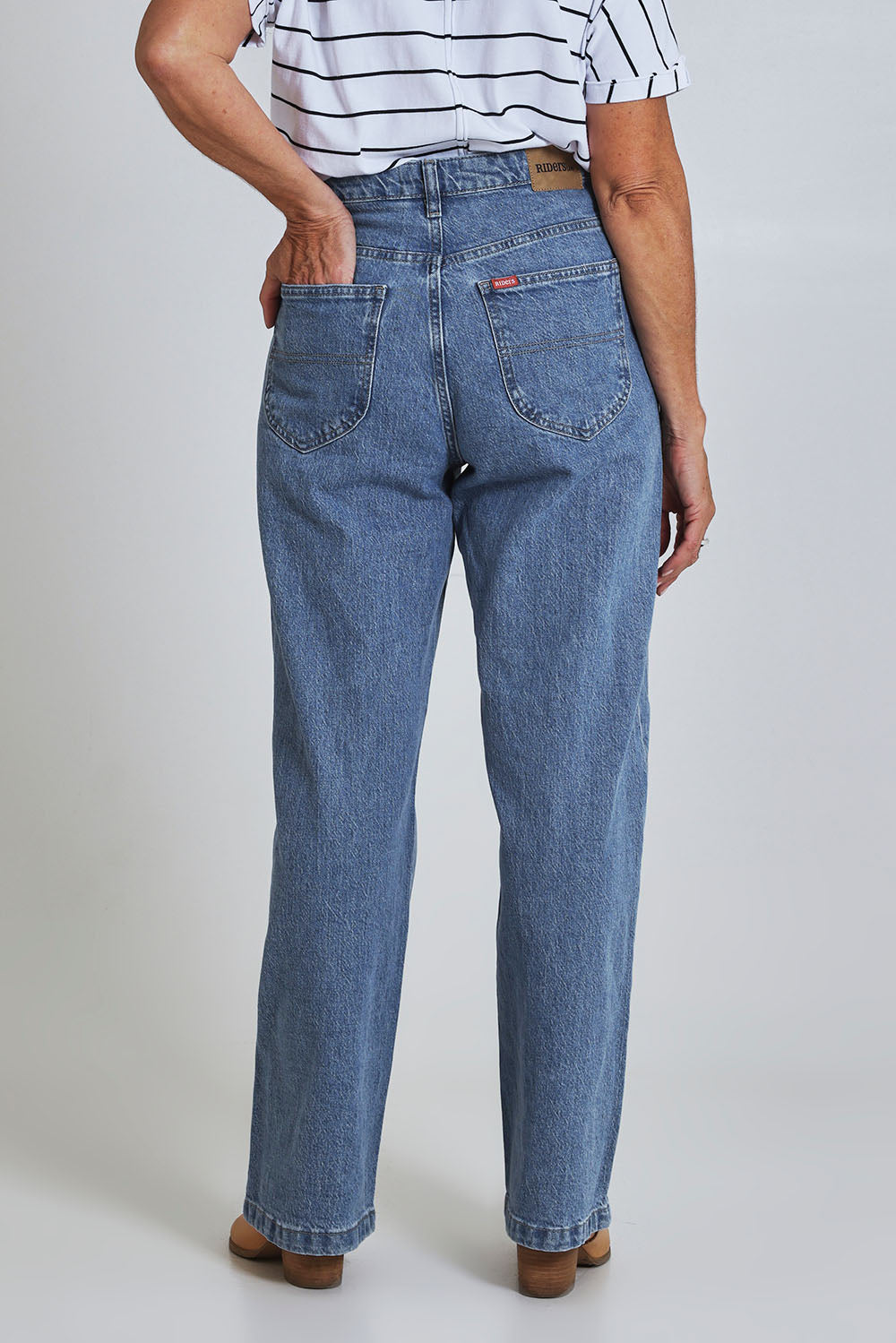 Model Sandy wearing size 10 of the Riders Hi Wide Leg Jean in colour Worninblue (Blue), from the back