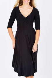 Model Maddy wearing size 10 of the Stella Dress in colour Black (Black), from the front, cropped image
